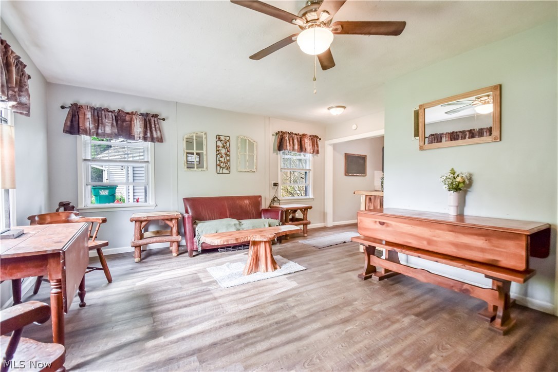 1969 Paisley Road Madison, OH 44057 - Photo 4 of 20 Spacious common area featuring wood-finish flooring, two windows, recessed lighting, and a ceiling fan with light fixture