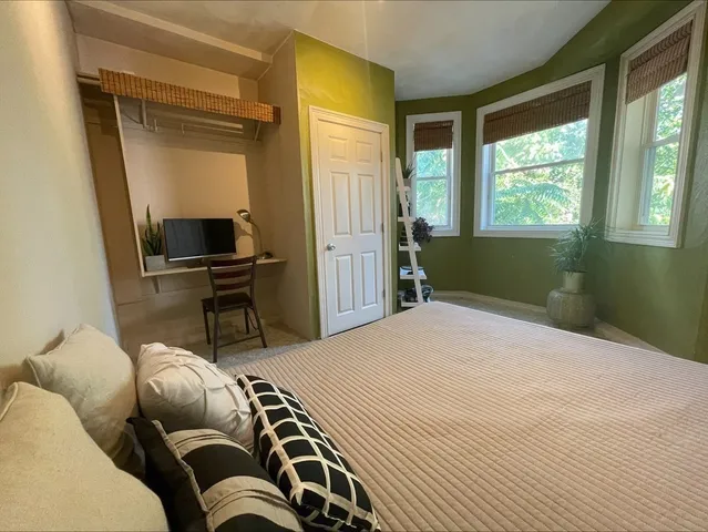 a bedroom with a bed and a window