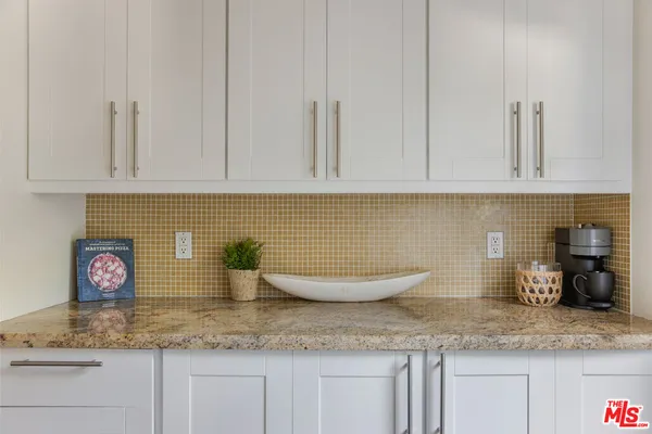 a kitchen with white cabinets