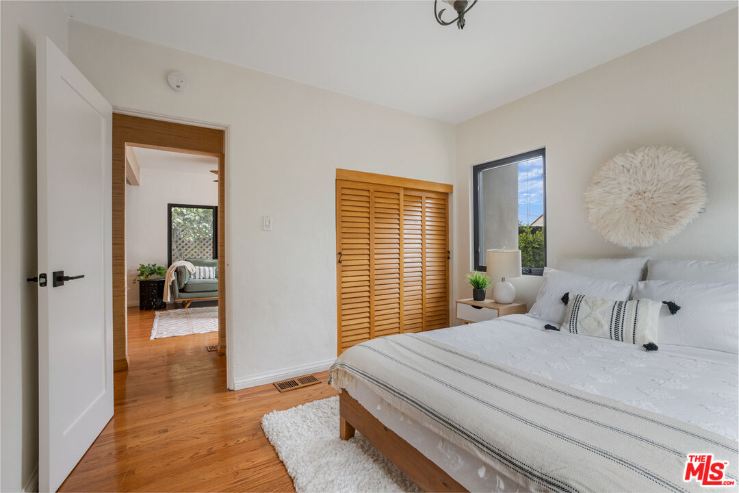 3004 Yale Avenue Marina del Rey, CA 90292 - Photo 28 of 42 a bedroom with a large bed and a chandelier