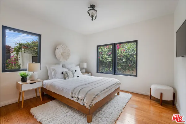 a bedroom with a bed a table and a window
