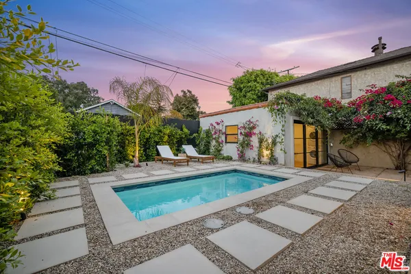 a view of a house with a yard and a garden