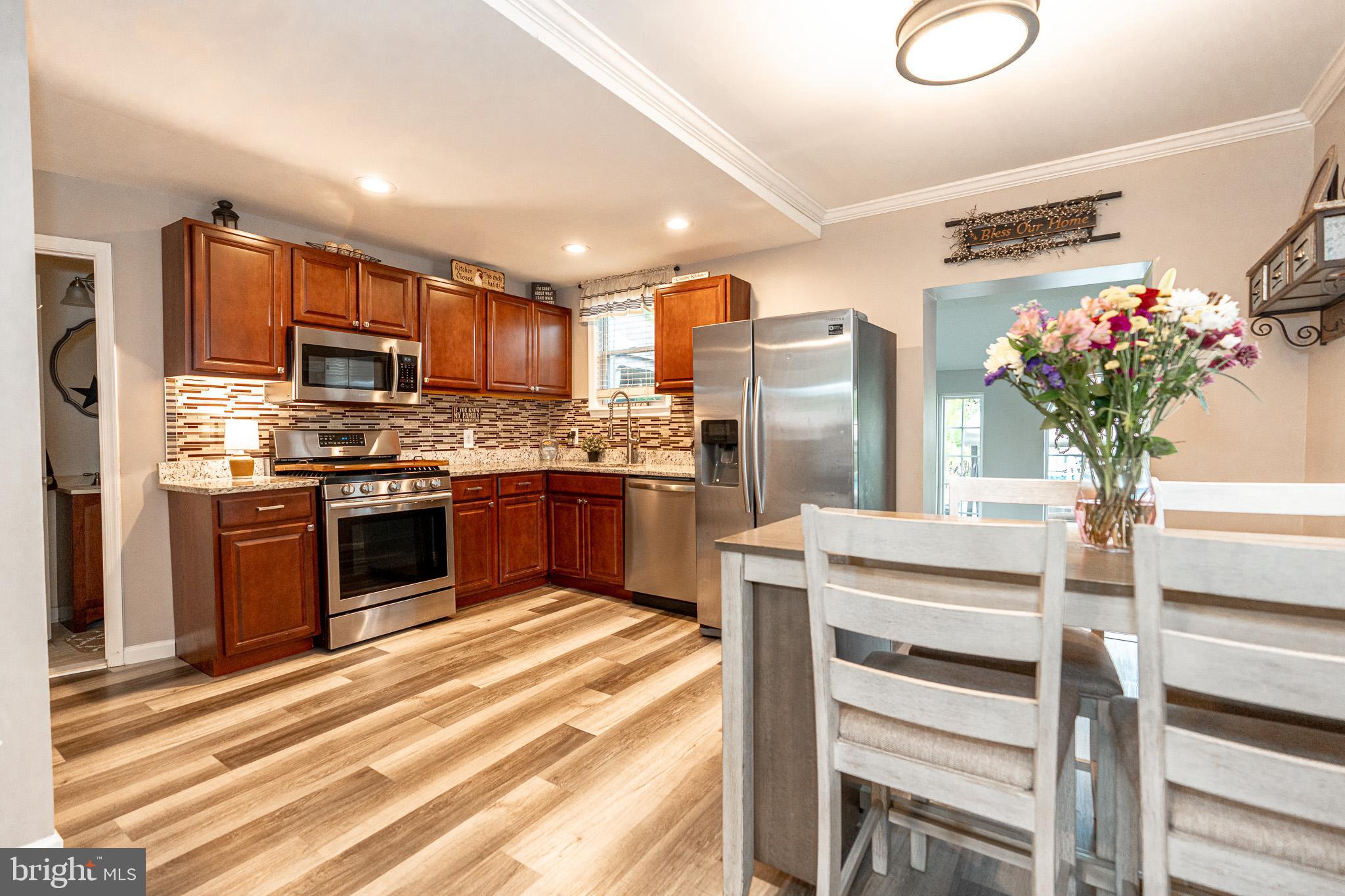 220 Pinewood Road Baltimore, MD 21222 - Photo 5 of 45 a kitchen with granite countertop stainless steel appliances and counter space