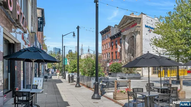 a view of a patio with chairs under an umbrella
