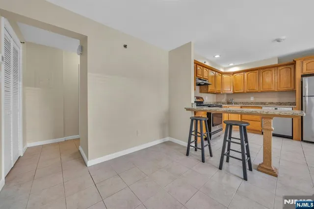 a view of kitchen with stainless steel appliances granite countertop cabinets and a counter top space