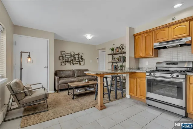 a living room with furniture and kitchen view
