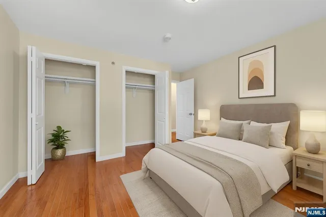 a bedroom with a bed and a potted plant