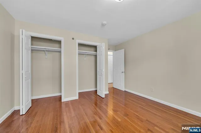 a view of an empty room and wooden floor