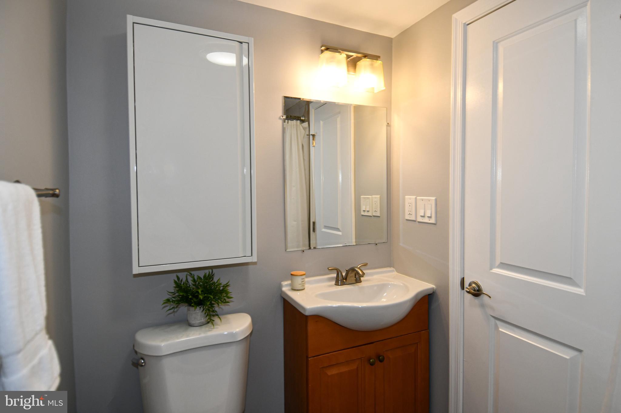 1643 Montello Avenue Northeast, Unit 4 Washington, DC 20002 - Photo 14 of 30 a bathroom with a sink toilet and mirror