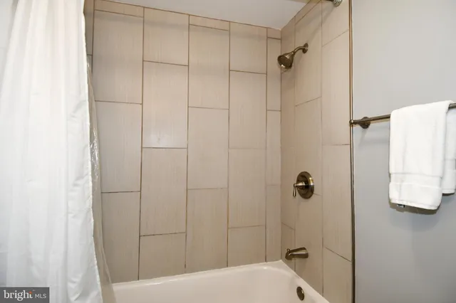 a bathroom with a shower and toilet