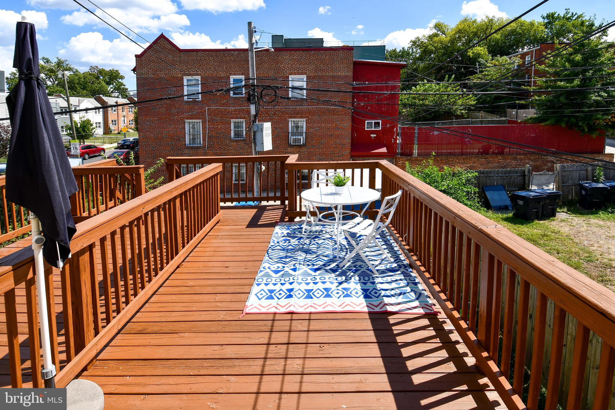 1643 Montello Avenue Northeast, Unit 4 Washington, DC 20002 - Photo 16 of 30 a view of a balcony with wooden floor and fence