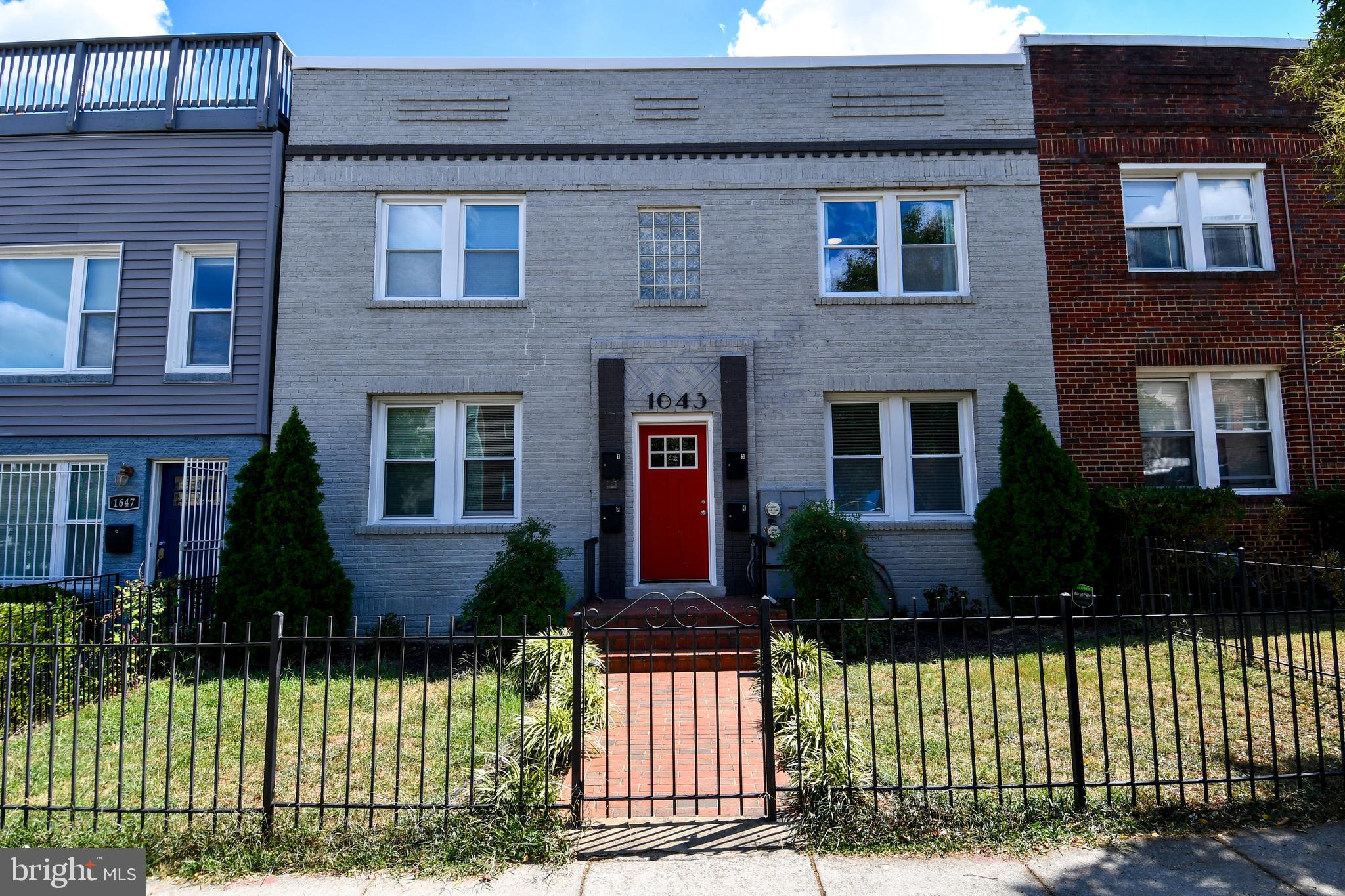 1643 Montello Avenue Northeast, Unit 4 Washington, DC 20002 - Photo 2 of 30 a front view of a house with a yard
