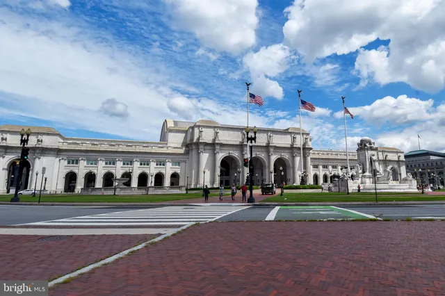 a view of a house with a big yard and potted plants