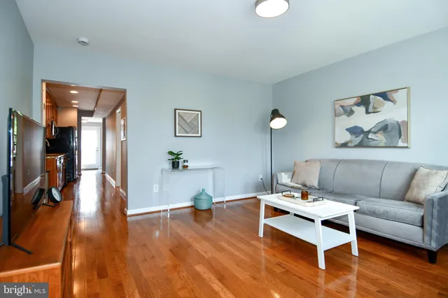a living room with furniture and wooden floor