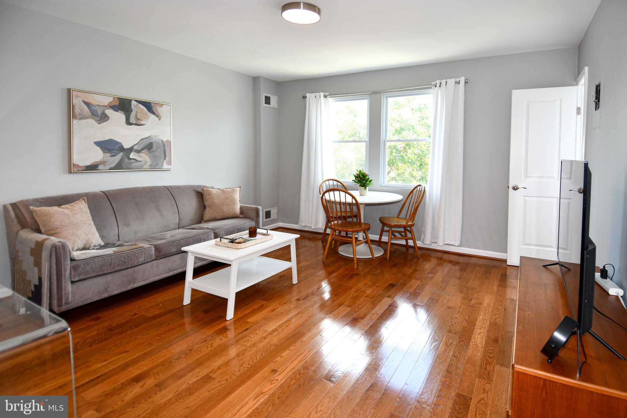 1643 Montello Avenue Northeast, Unit 4 Washington, DC 20002 - Photo 5 of 30 a living room with furniture and a large window