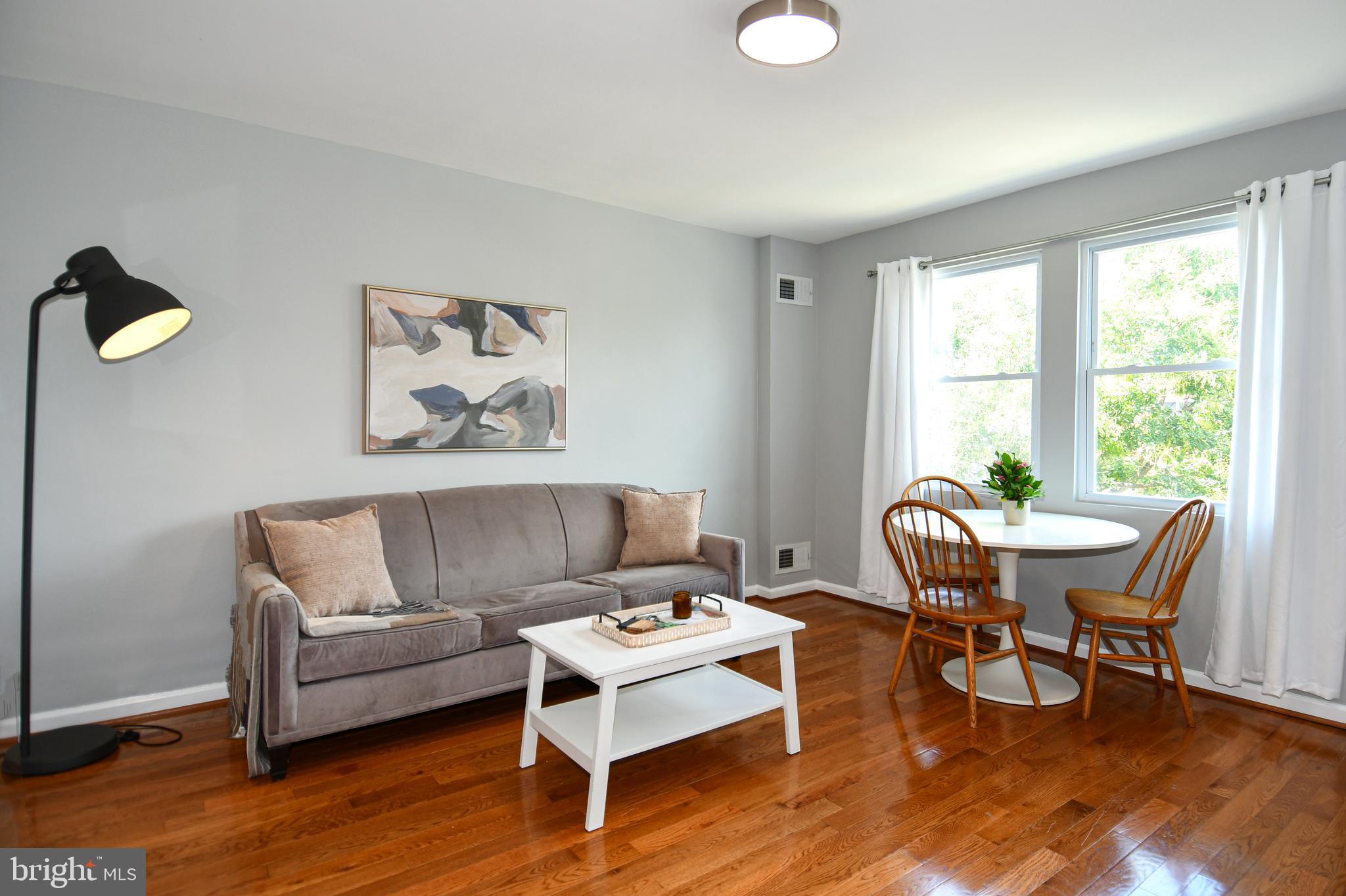 1643 Montello Avenue Northeast, Unit 4 Washington, DC 20002 - Photo 6 of 30 a living room with furniture and a wooden floor