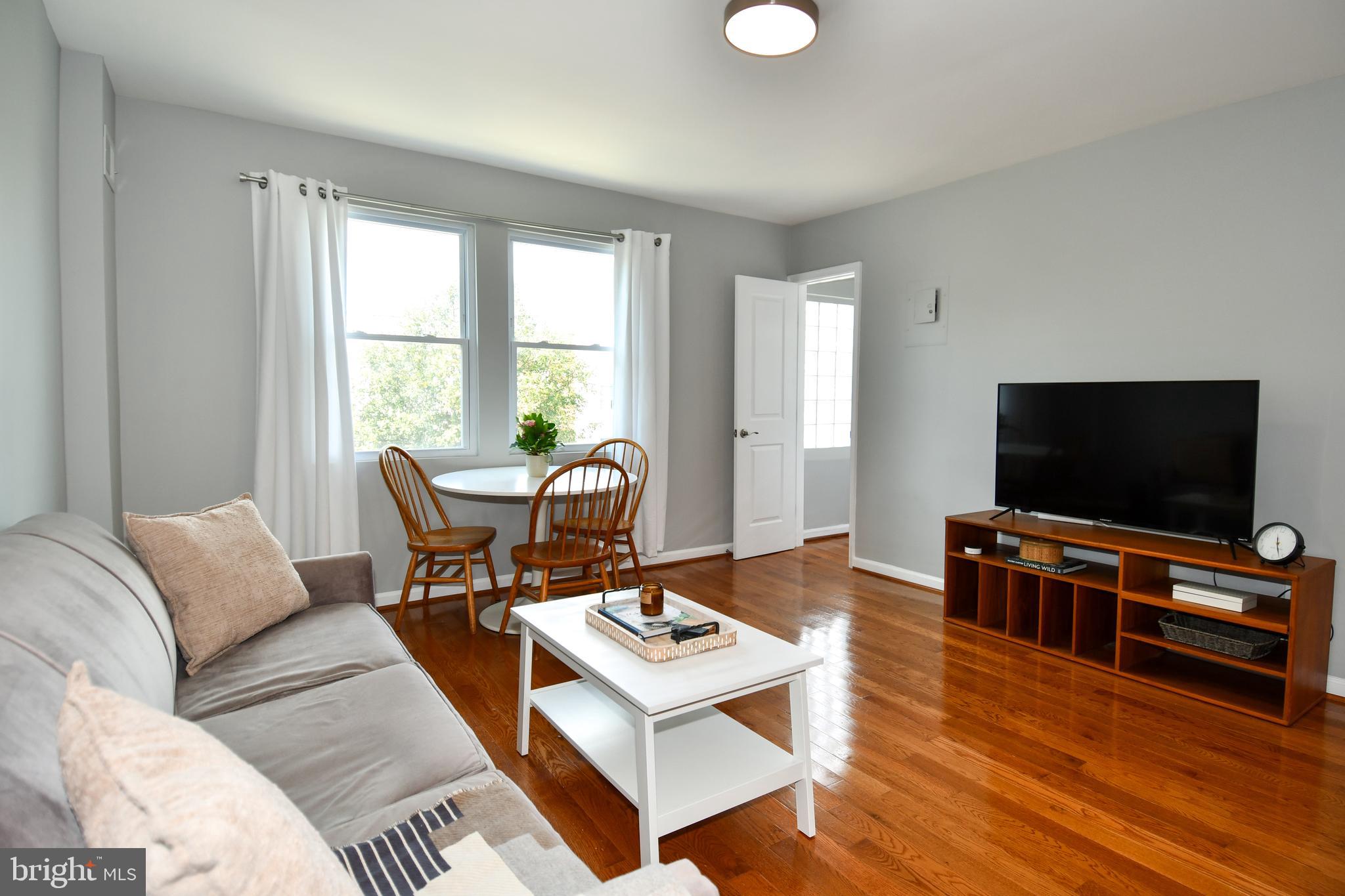 1643 Montello Avenue Northeast, Unit 4 Washington, DC 20002 - Photo 8 of 30 a living room with furniture and a flat screen tv