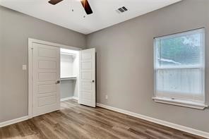 6814 Dumble Street, Unit B Houston, TX 77021 - Photo 17 of 22 a view of an empty room with wooden floor and a window