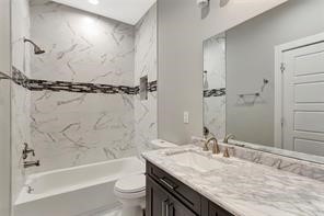 6814 Dumble Street, Unit B Houston, TX 77021 - Photo 18 of 22 a bathroom with a granite countertop sink toilet and shower