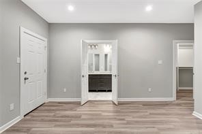 6814 Dumble Street, Unit B Houston, TX 77021 - Photo 10 of 22 a view of an empty room with wooden floor and a window