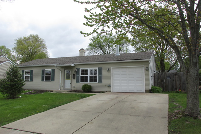 a view of backyard of house garage and trees