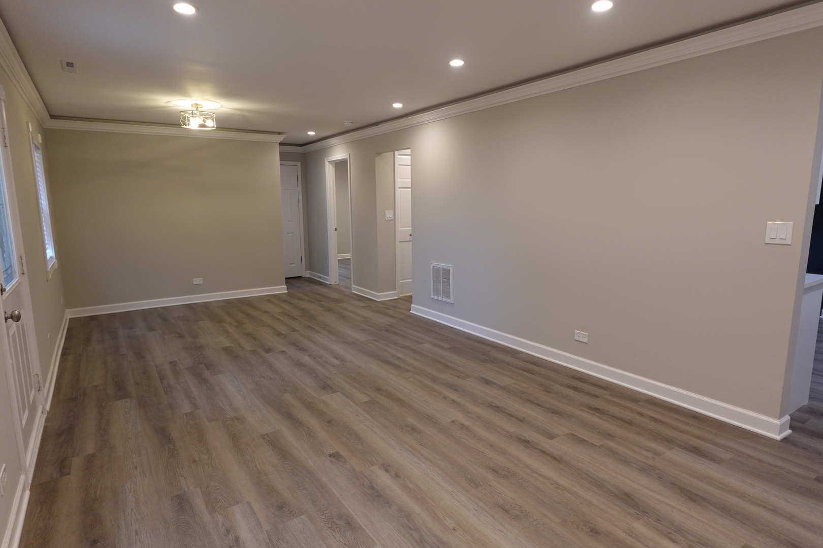 613 South Oltendorf Road Streamwood, IL 60107 - Photo 7 of 37 an empty room with wooden floor and natural light