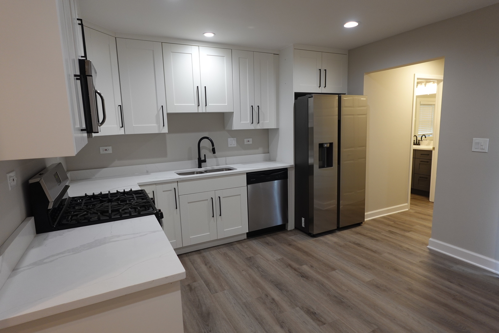 613 South Oltendorf Road Streamwood, IL 60107 - Photo 9 of 37 a kitchen with a sink a refrigerator and cabinets