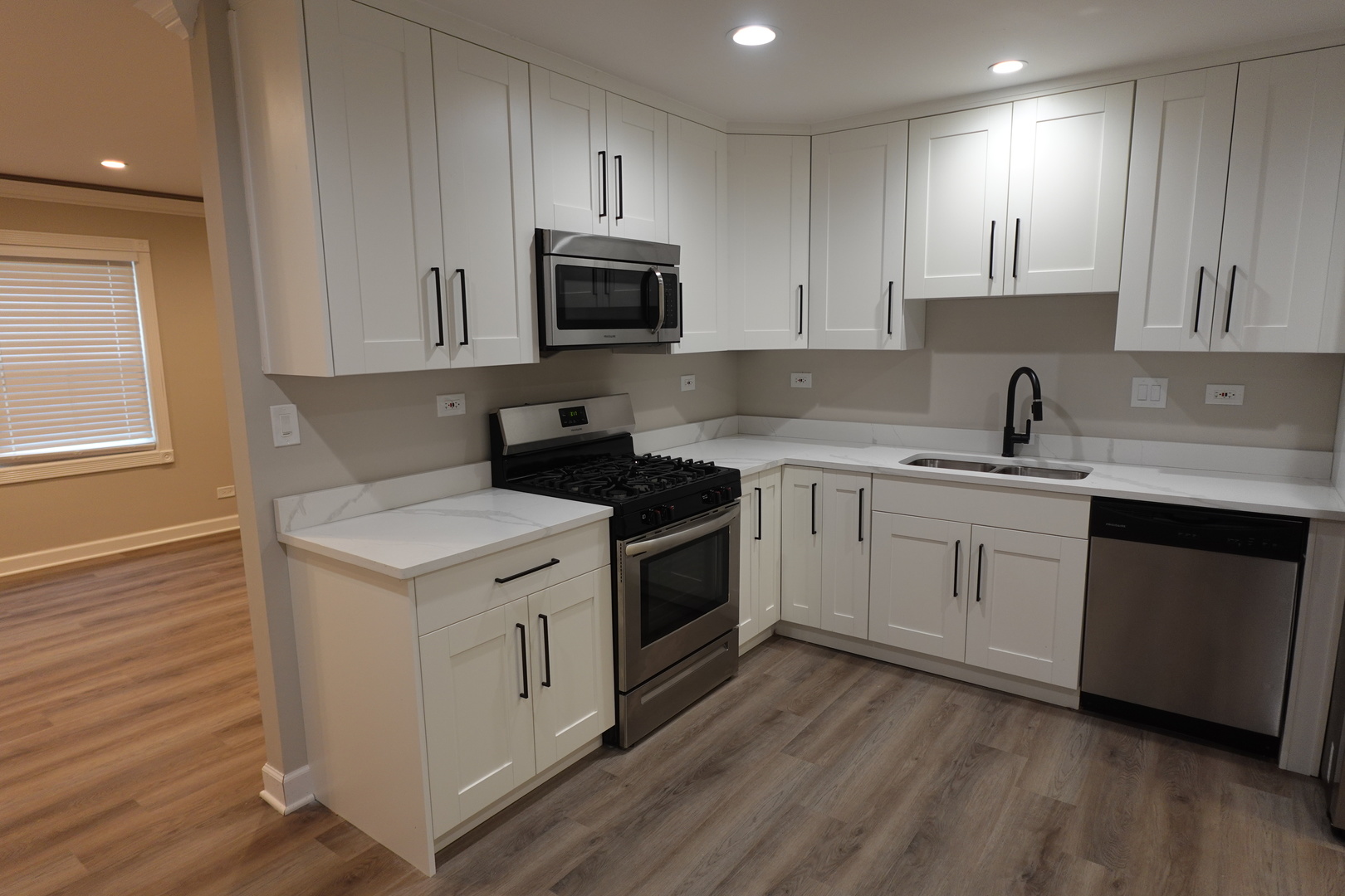 613 South Oltendorf Road Streamwood, IL 60107 - Photo 10 of 37 a kitchen with white cabinets stainless steel appliances and sink