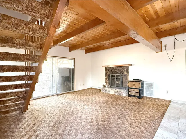 a view of a livingroom with furniture and a kitchen