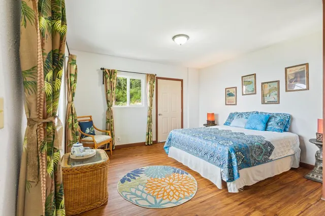 a bedroom with a large bed and a chandelier