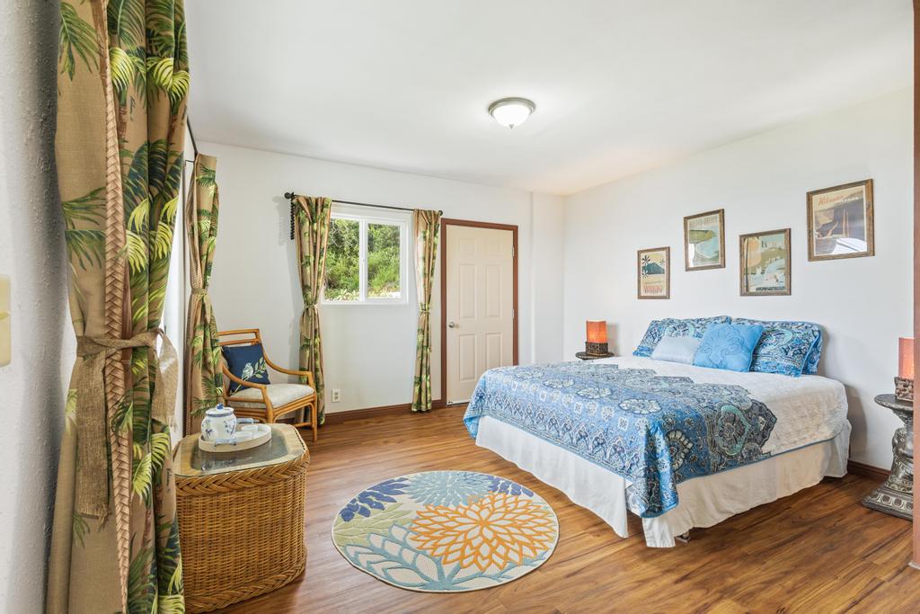 87-2707 Hawaii Belt Road Captain Cook, HI 96704 - Photo 24 of 30 a bedroom with a bed and wooden floor