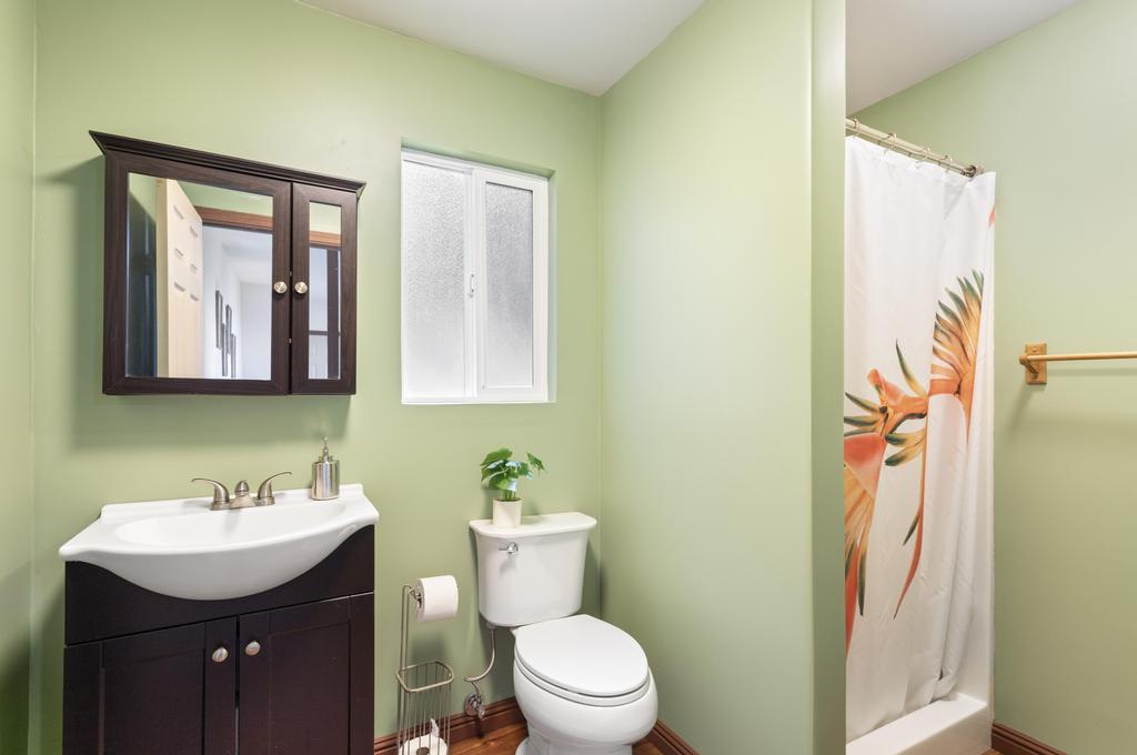 87-2707 Hawaii Belt Road Captain Cook, HI 96704 - Photo 26 of 30 a bathroom with a toilet sink and mirror