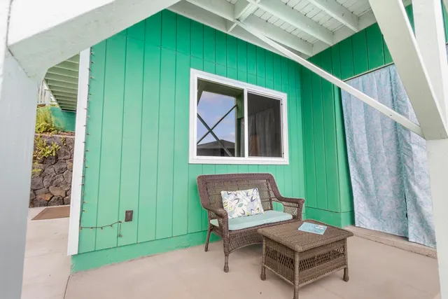 a balcony with wooden floor stairs and wooden fence