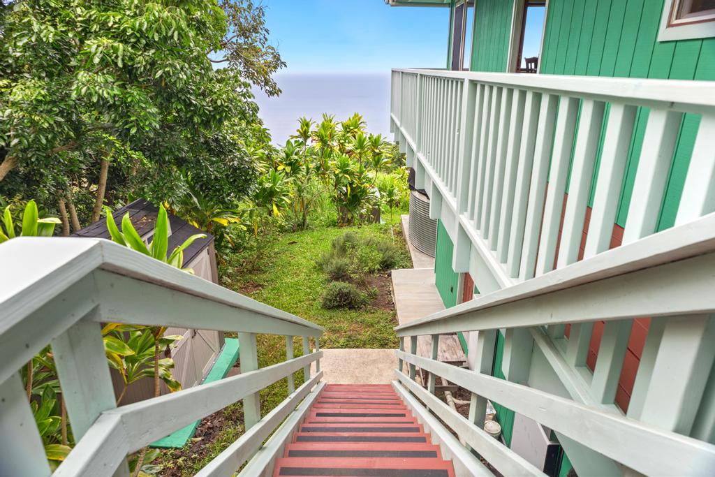 87-2707 Hawaii Belt Road Captain Cook, HI 96704 - Photo 28 of 30 a balcony with wooden floor stairs and wooden fence