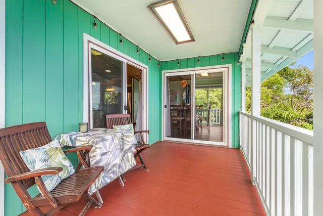 a balcony with furniture and a garden