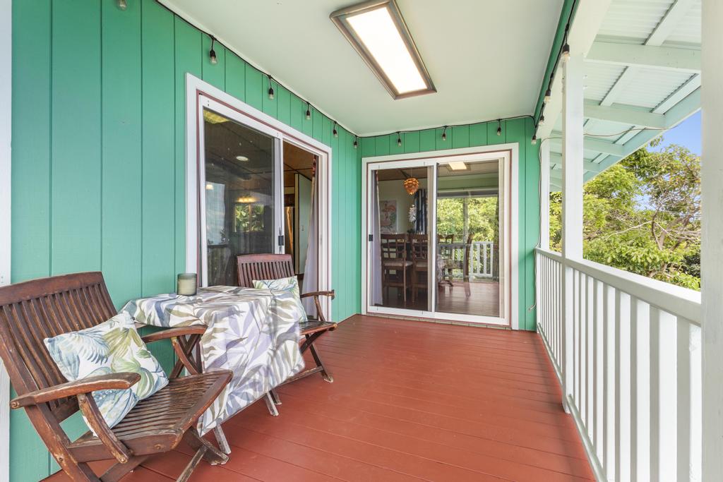 87-2707 Hawaii Belt Road Captain Cook, HI 96704 - Photo 5 of 30 a balcony with furniture and a garden