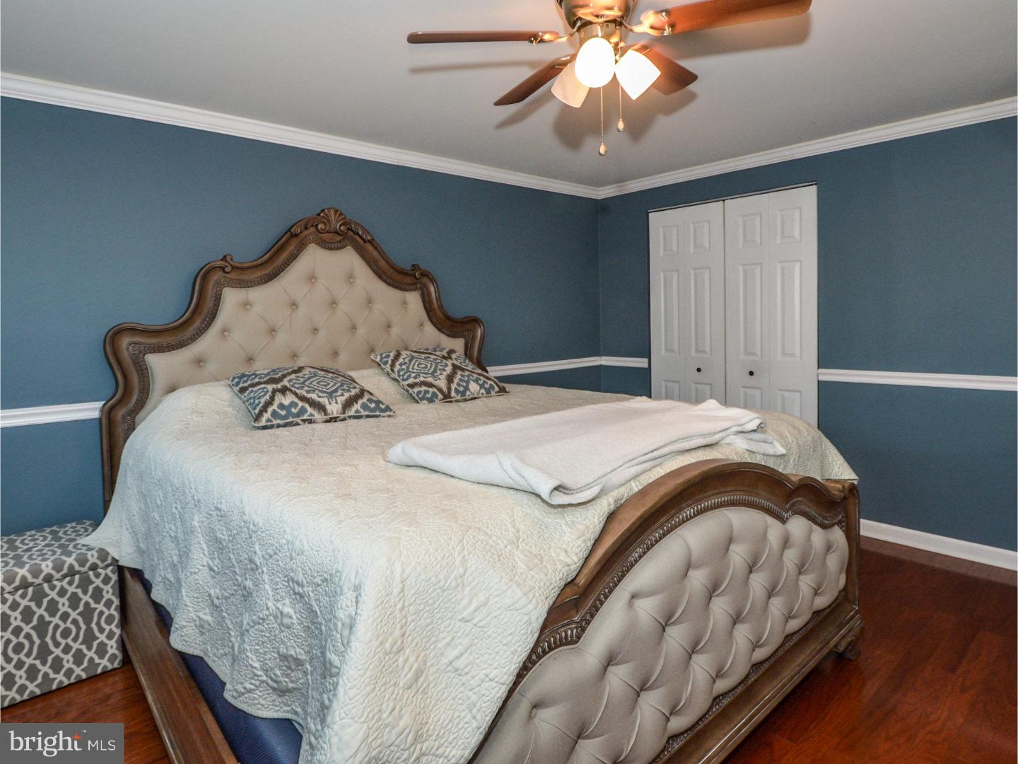 9734 Beacon Road Philadelphia, PA 19115 - Photo 16 of 25 a bed sitting in a bedroom next to a window and a chandelier