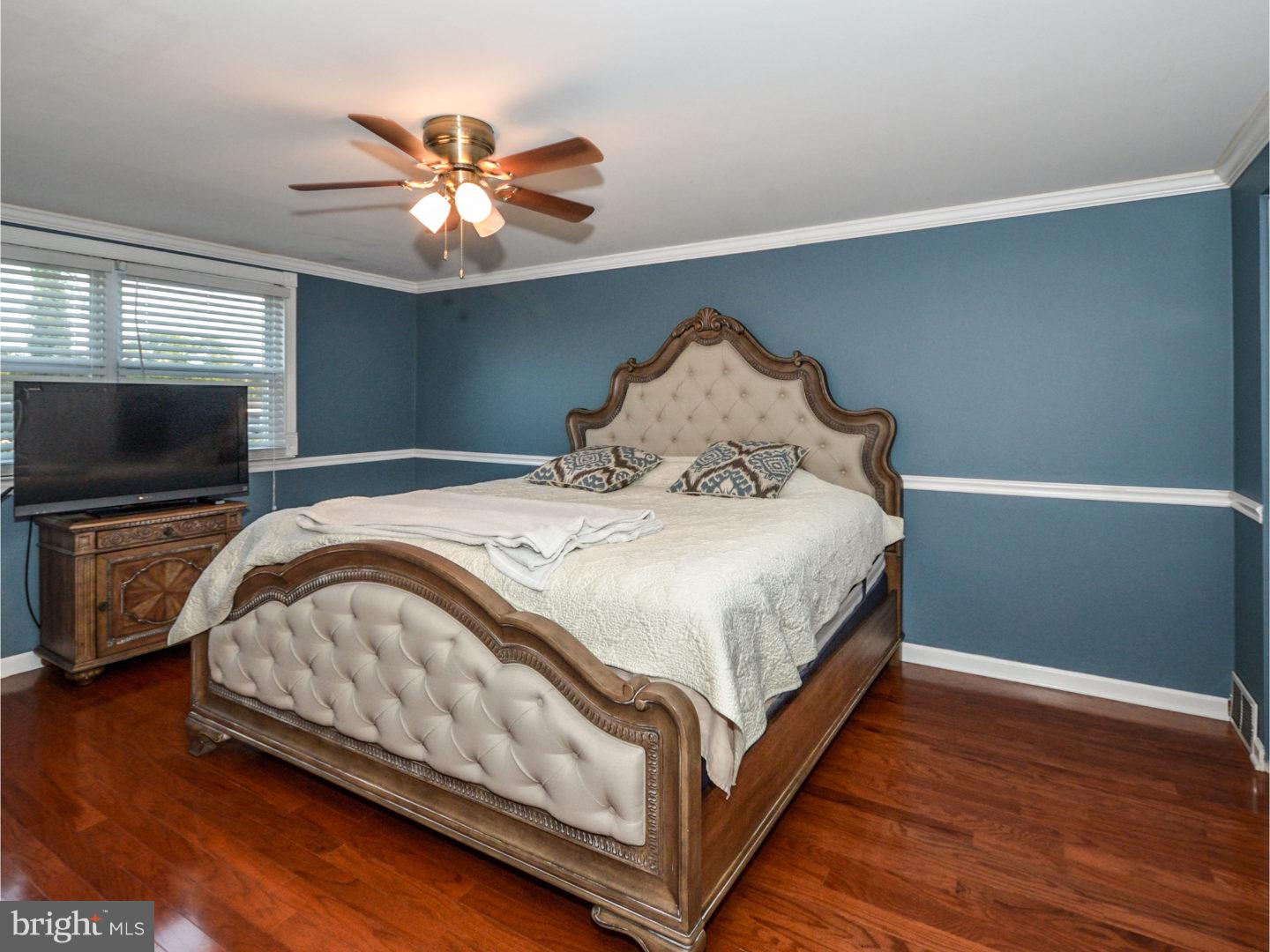 9734 Beacon Road Philadelphia, PA 19115 - Photo 17 of 25 a bedroom with a bed and a flat screen tv