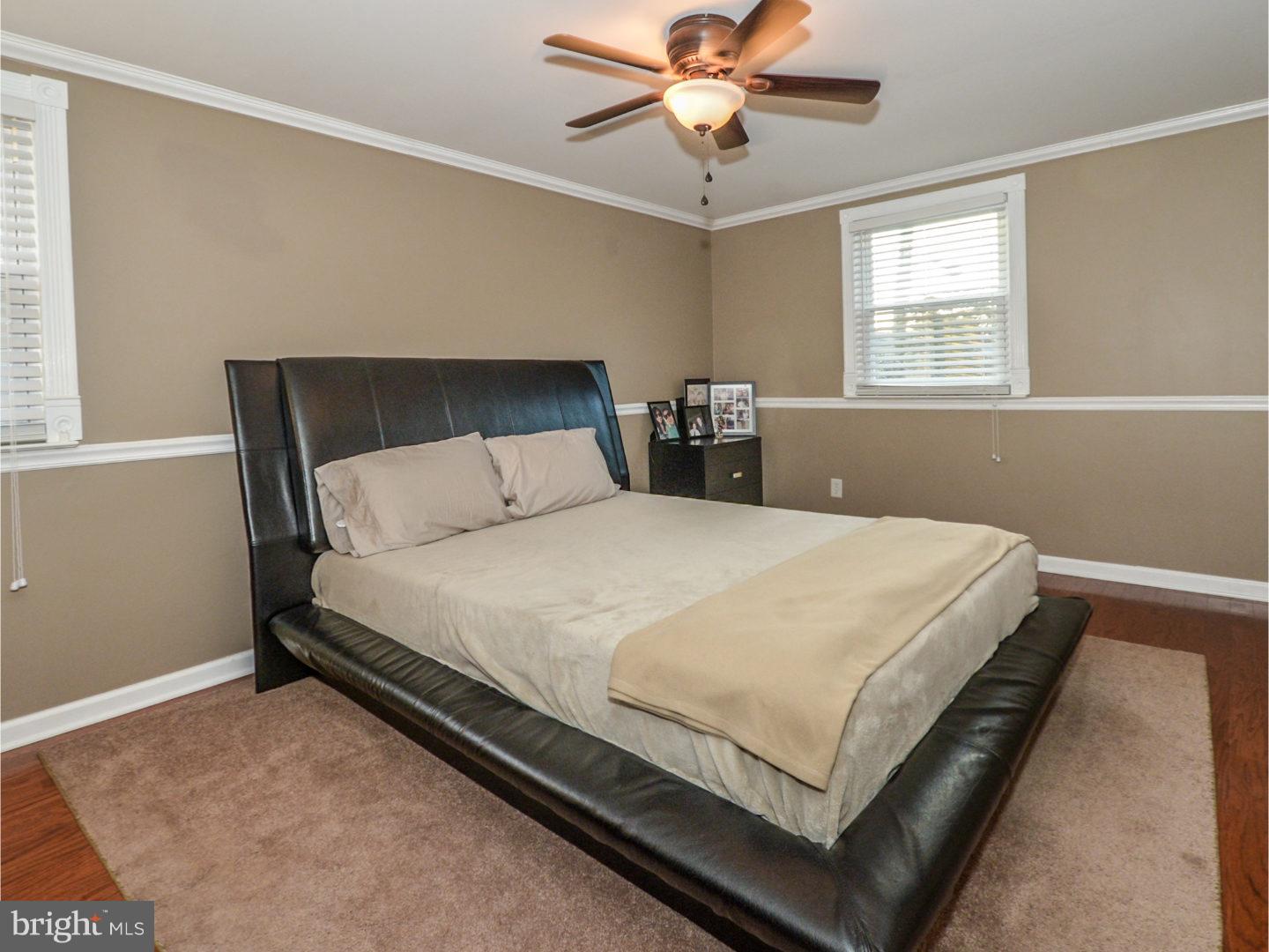 9734 Beacon Road Philadelphia, PA 19115 - Photo 18 of 25 a bed sitting in a bedroom next to a window