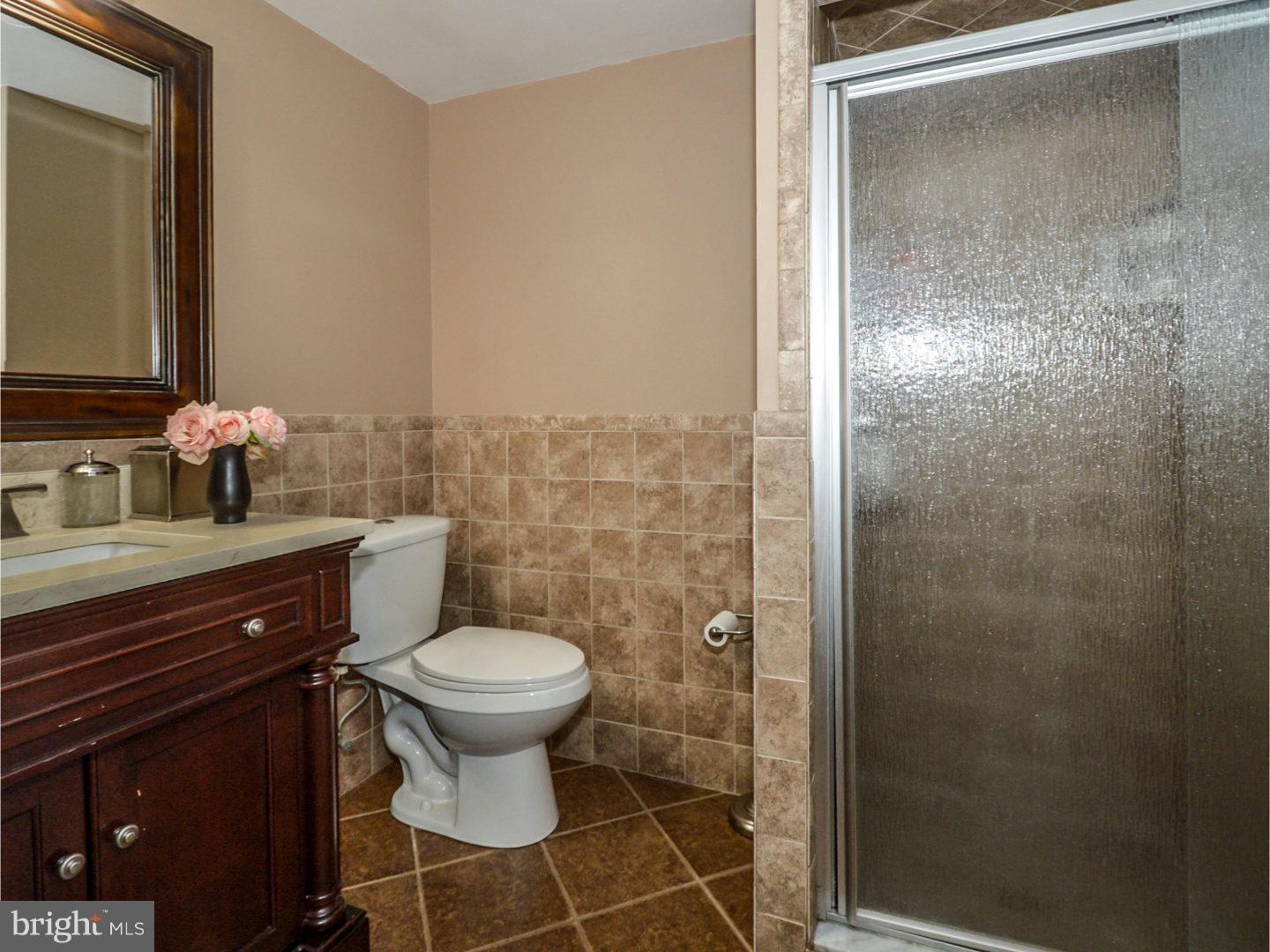 9734 Beacon Road Philadelphia, PA 19115 - Photo 20 of 25 a bathroom with a sink toilet and shower