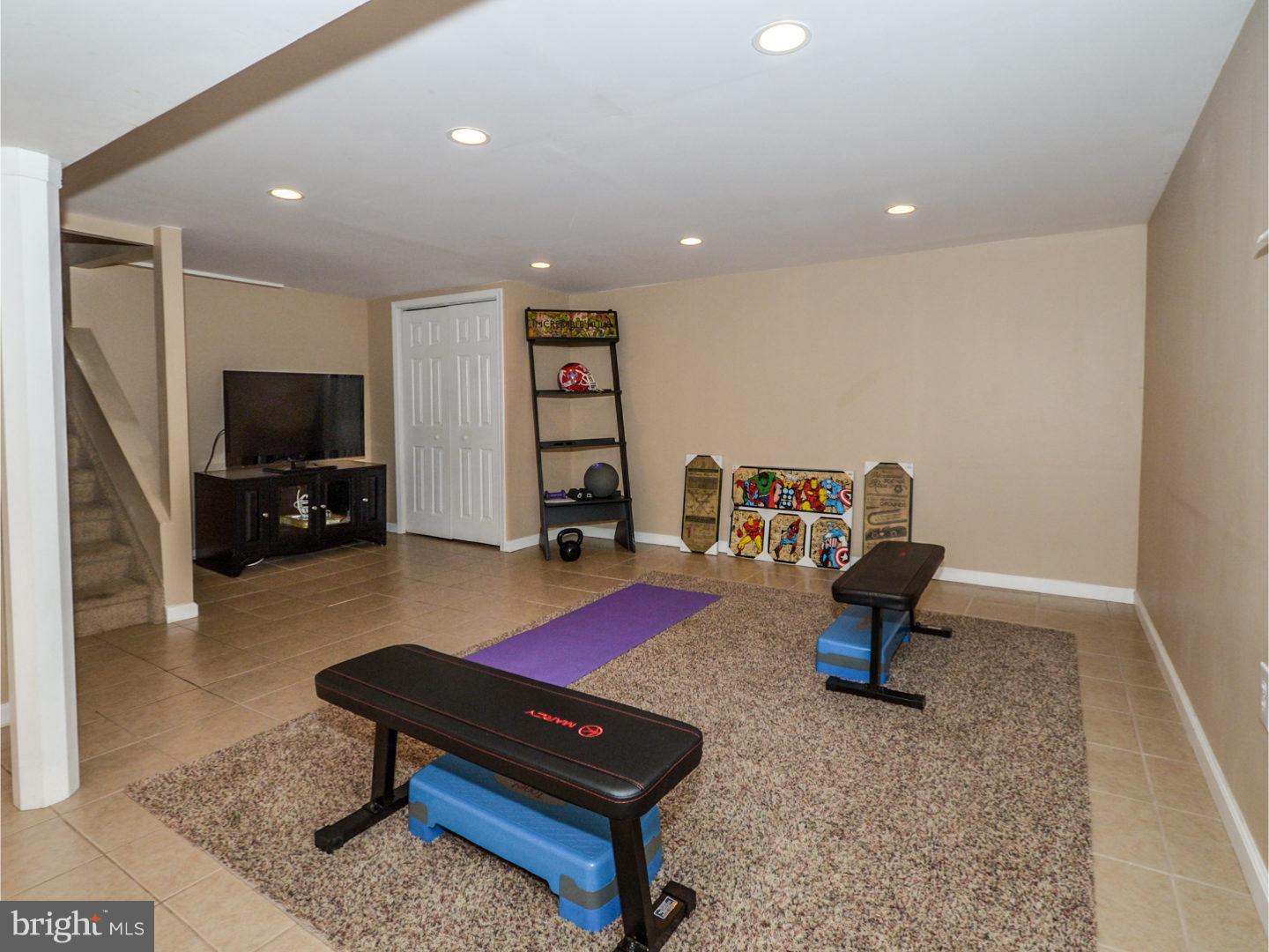 9734 Beacon Road Philadelphia, PA 19115 - Photo 21 of 25 a living room with furniture and a flat screen tv