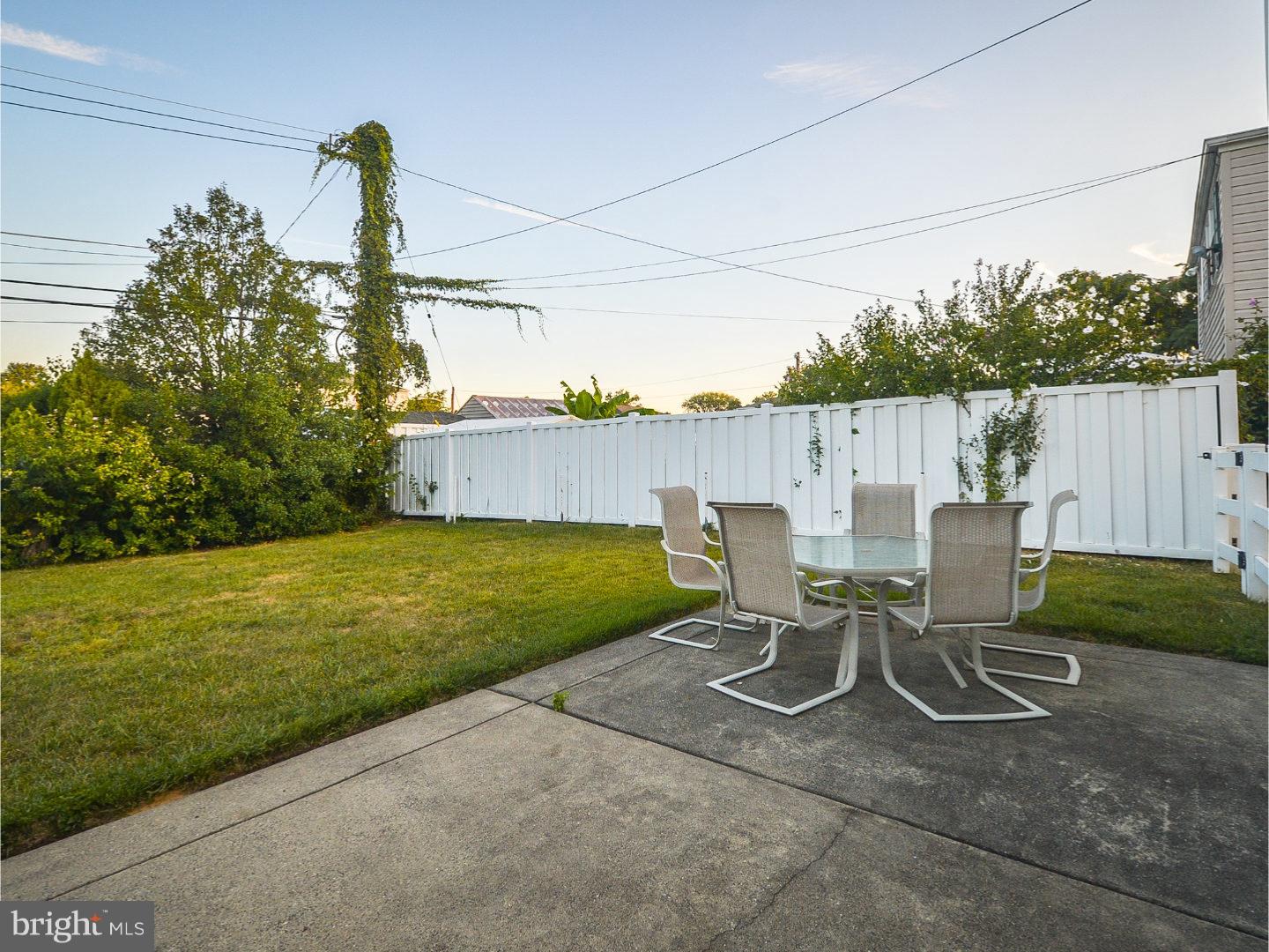 9734 Beacon Road Philadelphia, PA 19115 - Photo 24 of 25 a view of a patio with table and chairs with wooden fence