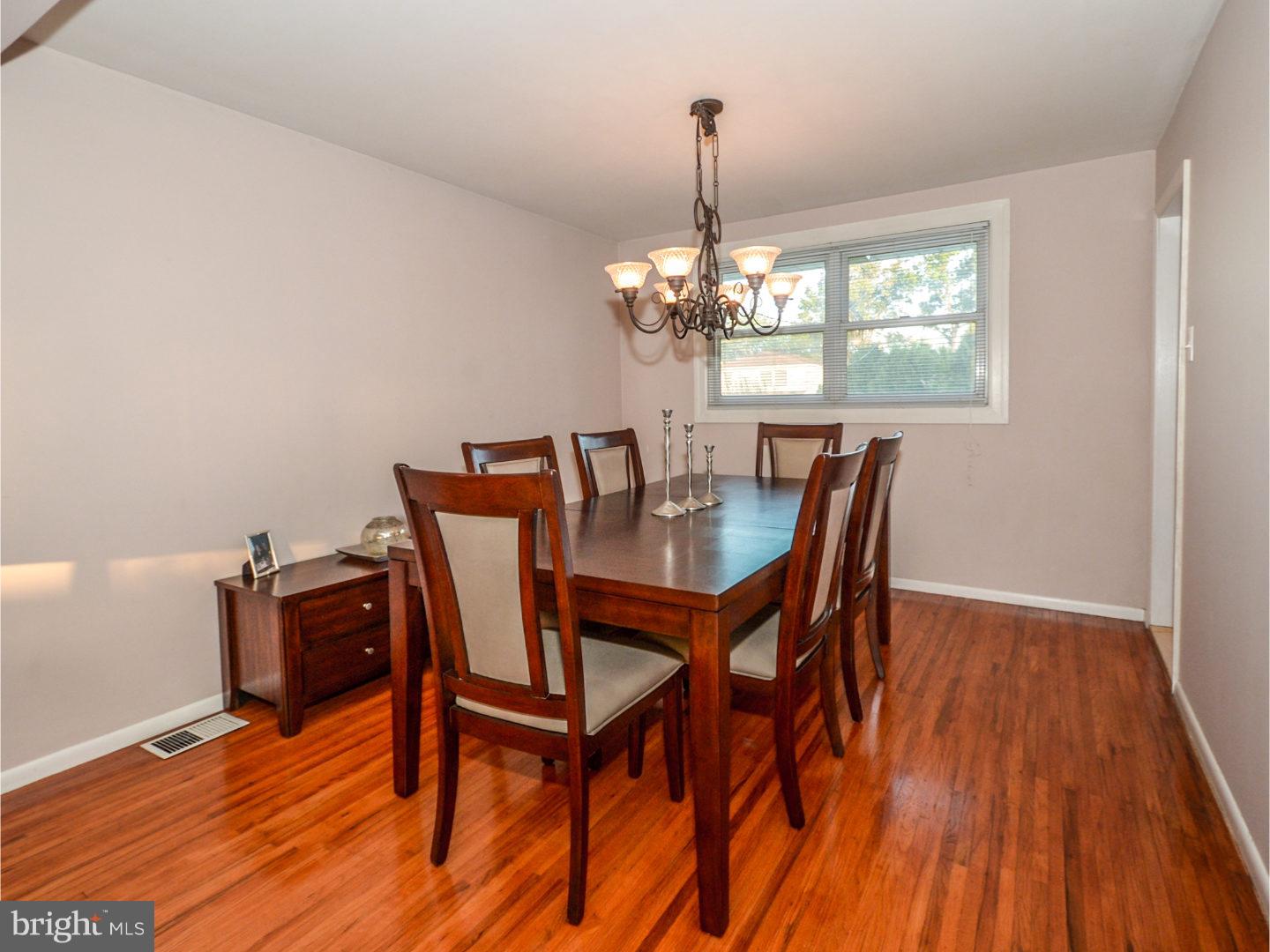 9734 Beacon Road Philadelphia, PA 19115 - Photo 8 of 25 a view of a dining room with furniture wooden floor and chandelier