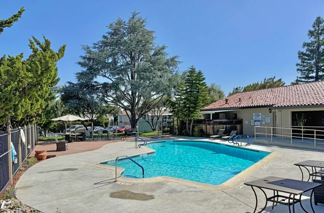 a view of a house with swimming pool and sitting area