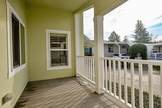 a view of a balcony with wooden floor
