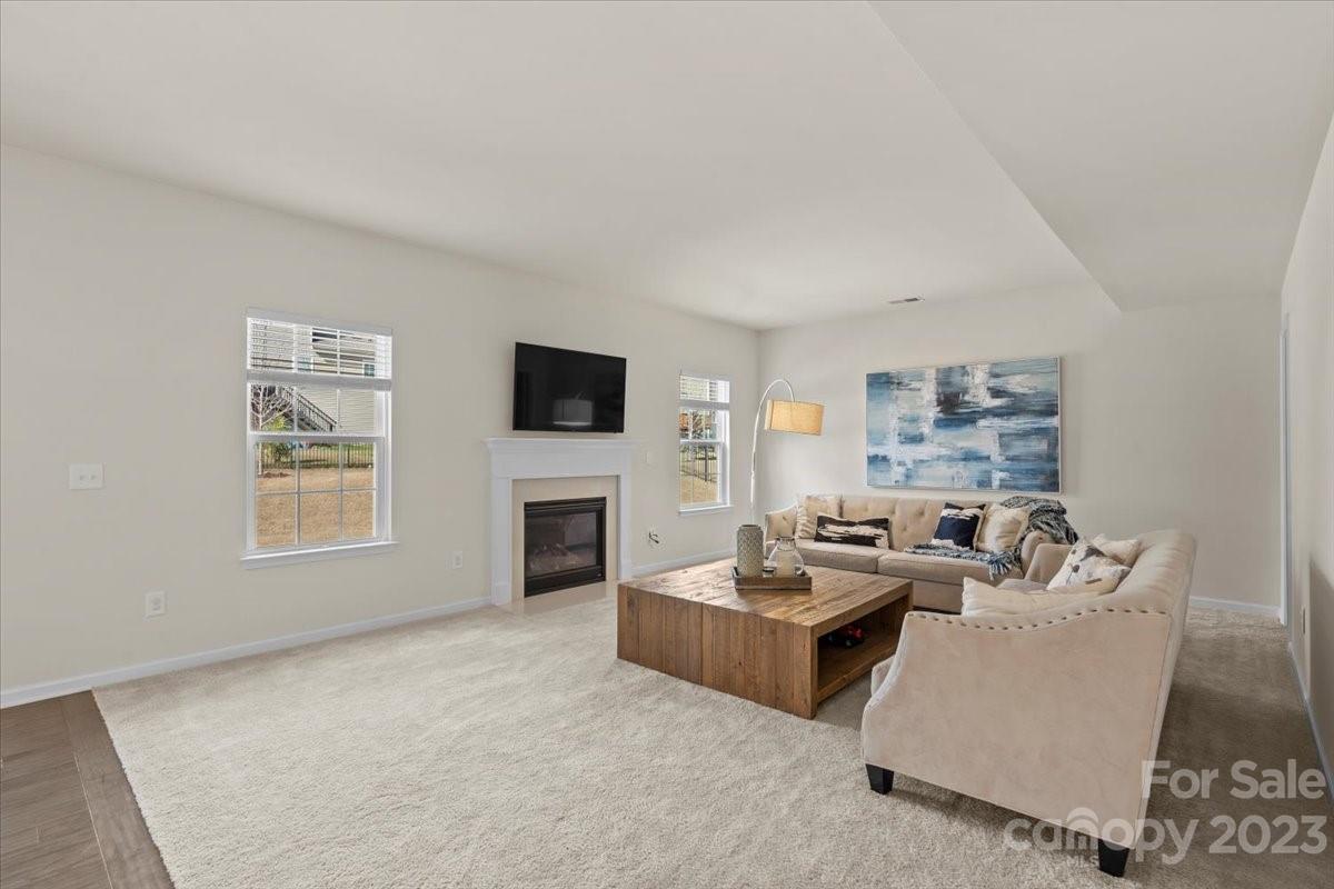 1662 Callahan Road Fort Mill, SC 29715 - Photo 11 of 42 a living room with furniture a fireplace and a flat screen tv