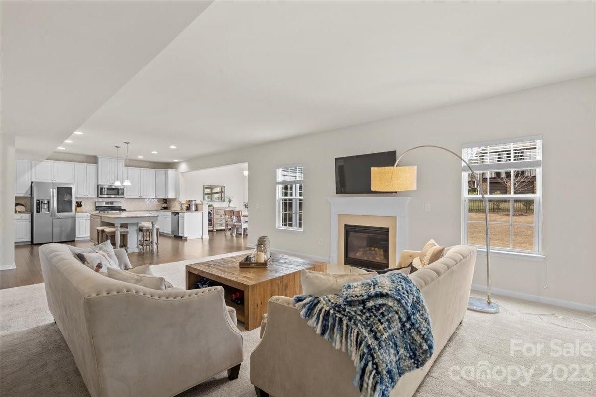 1662 Callahan Road Fort Mill, SC 29715 - Photo 12 of 42 a living room with furniture a fireplace and a table