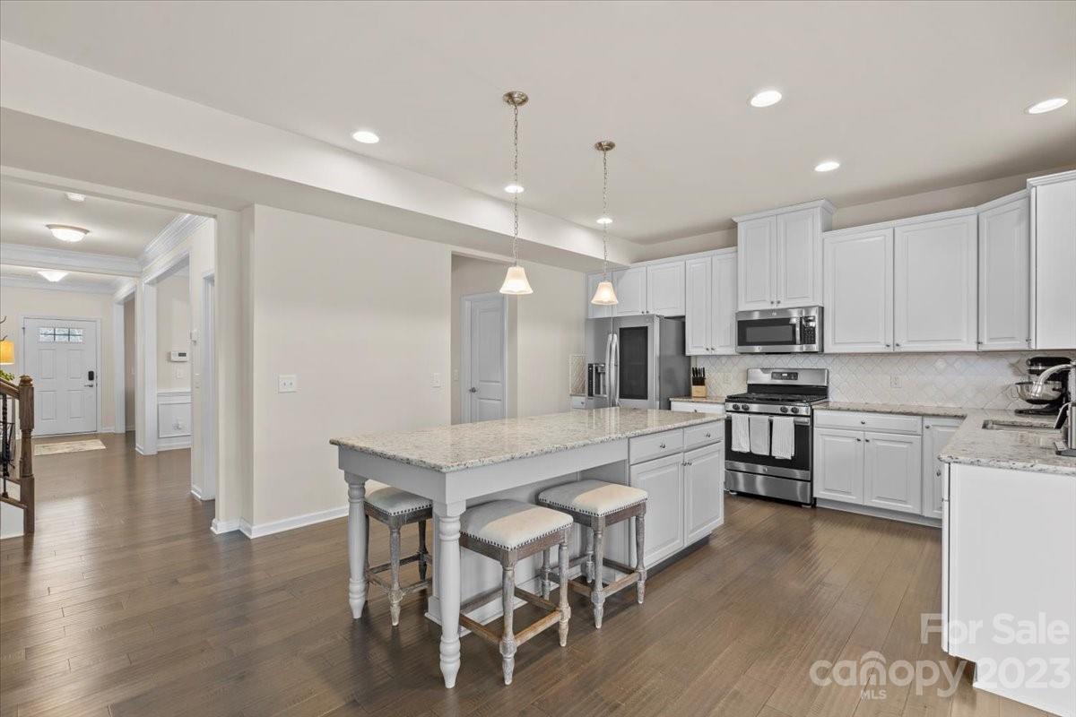 1662 Callahan Road Fort Mill, SC 29715 - Photo 14 of 42 a large kitchen with cabinets chairs and wooden floor