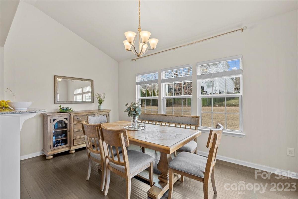 1662 Callahan Road Fort Mill, SC 29715 - Photo 17 of 42 a view of a dining room with furniture a chandelier and wooden floor