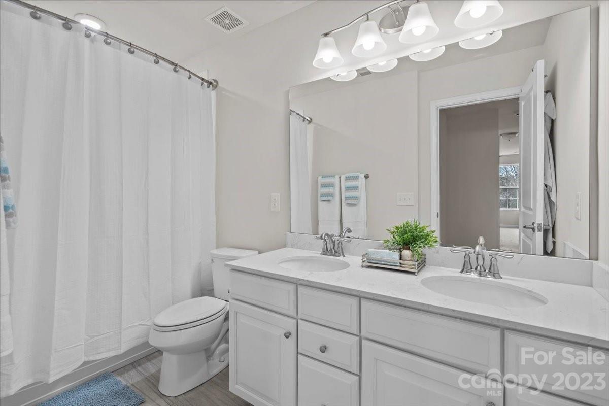 1662 Callahan Road Fort Mill, SC 29715 - Photo 32 of 42 a bathroom with a double vanity sink mirror and toilet